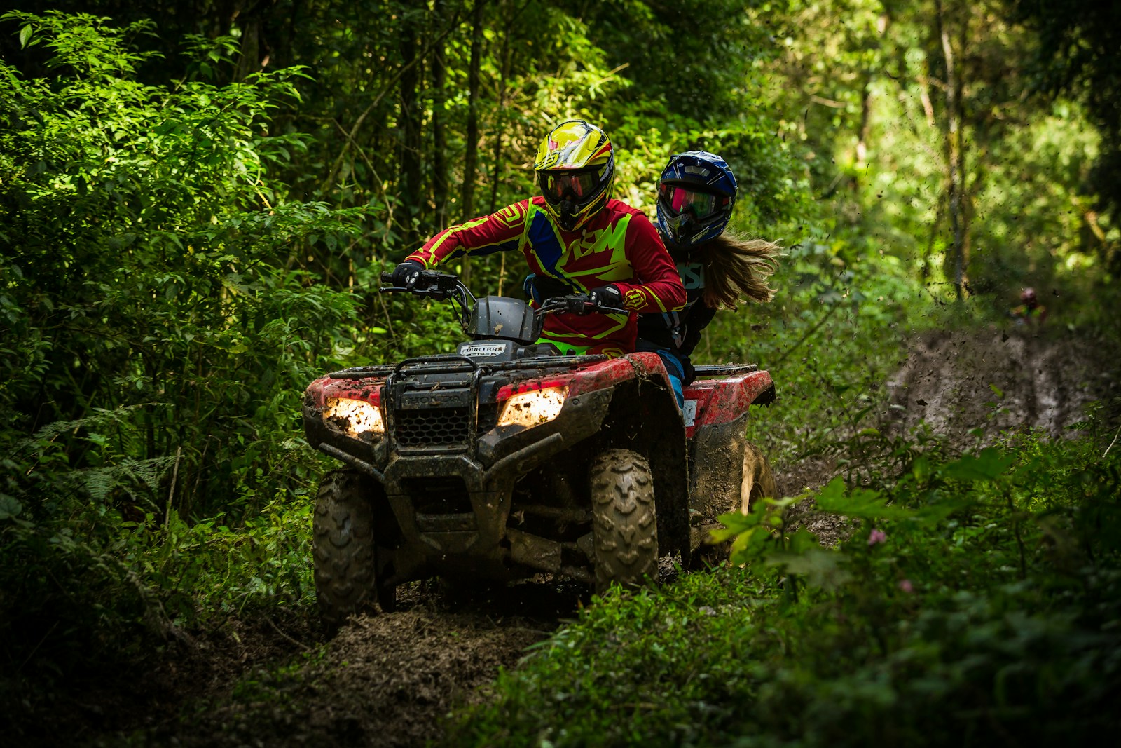 man and woman riding on ATV & boat insutrance